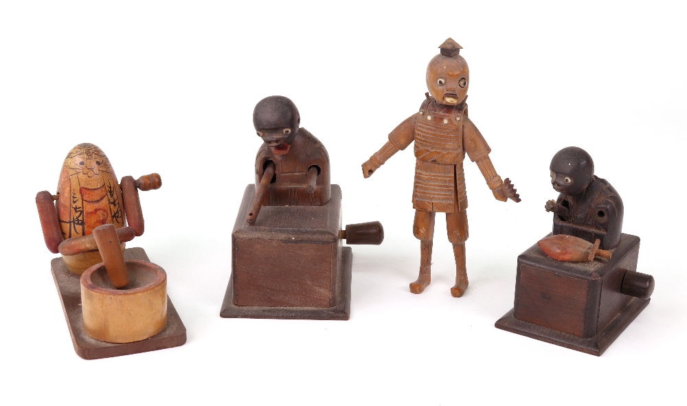 Four carved wooden Japanese Kobi toys, to include two figures on boxes,