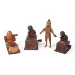 Four carved wooden Japanese Kobi toys, to include two figures on boxes,