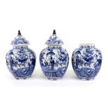 A garniture of three Dutch Delft lobed oviform vases and two later matched covers, 18th century,