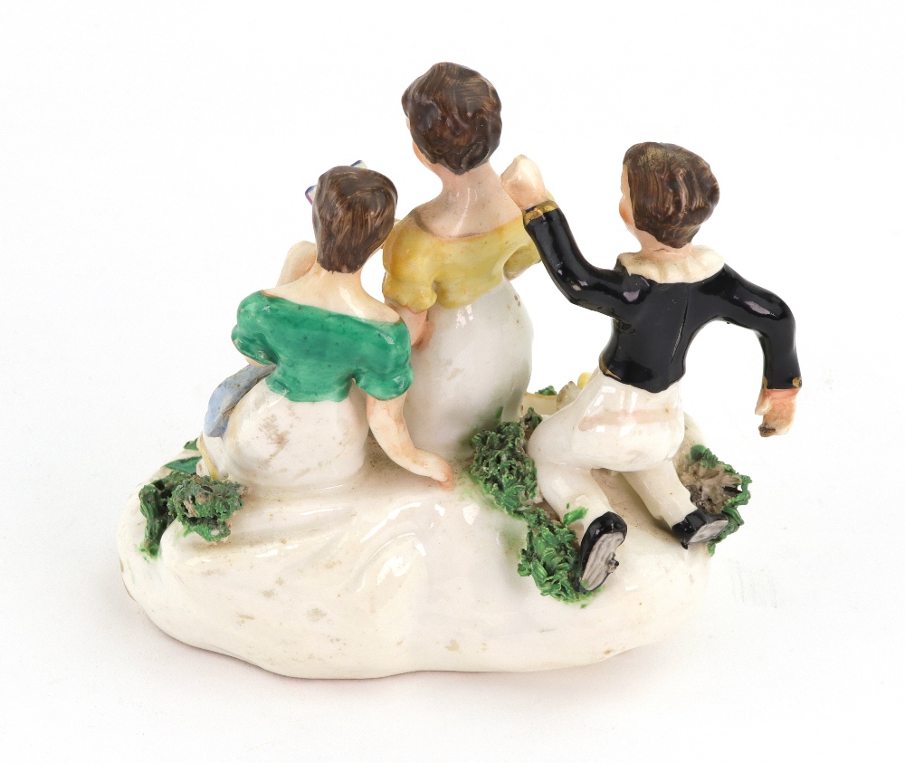 An English porcelain group, circa 1830, modelled as a mother holding an open book, - Image 2 of 2