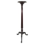 A reproduction Hepplewhite style mahogany torchere, circa 1900, the dished circular top on a turned,