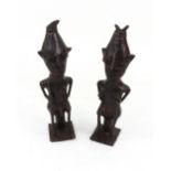 A pair of African tribal bronzes, of a seated man and woman, possibly Yoruba, both nude,