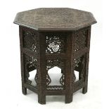 An Indian hardwood octagonal table, second half 19th century, carved with flowering branches,
