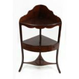 A George III mahogany boxwood banded bow fronted three tier corner washstand,