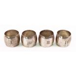 A set of four Edwardian circular silver napkin rings, Mappin & Webb, Sheffield 1903, numbered 1-IV,