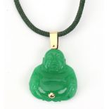 A carved green jade Buddha pendant, in seated position with a yellow metal belly button,