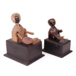Two carved wooden Japanese Kobi toys, both of figures on boxes,