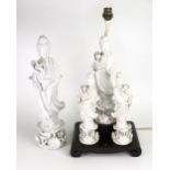 Three Chinese blanc de chine figures of Guanyin, 20th century, each standing holding a lotus flower,