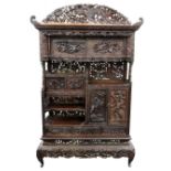 A Japanese carved rosewood Shodana (shelf cabinet), Meiji period, carved and pierced with birds,