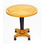 An Art Deco birchwood and ebonised low table, Swedish, 1920's, the circular quarter veneered top,