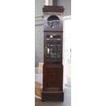 An Art Deco oak longcase clock case, 203cm high, and two weights, lacking movement. .