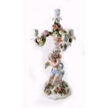 A Sitzendorf porcelain three light candelabrum encrusted with roses, having scrolling branches,