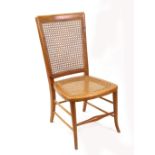 A Victorian style walnut nursing chair, 20th century, with cane panel back and seat,
