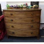 A Regency mahogany bowfront chest, fitted with four long boxwood strung drawers,