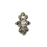 A white metal and diamond ring in a pierced abstract design,