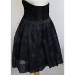 A black velvet skirt, by Martinique, a black linen underskirt, and a black appliqued cardigan,