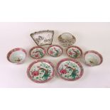 A pair of Chinese famille-rose plates, pair of bowls and three small dishes, painted with peacocks,