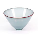 A Lindean Mill glass bowl, blue/grey with rust colour rim, dated '84, 19.5cm diameter.