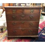 An early 18th century oak chest, the rectangular top above two short and three long drawers,