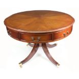 A reproduction Regency style mahogany drum library table,
