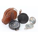 Negretti & Zambra, London - a circular japanned brass cased pocket compass in leather carrying case,