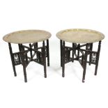 A pair of Indian brass tray tables, late 19th century, with lobed sided sunken centres,