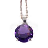 An 18ct white gold and synthetic purple sapphire pendant, 15.2mm diam.