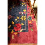 A modern Chinese carpet, with blue field and plum border, decorated with flowers, 362 x 278cm.