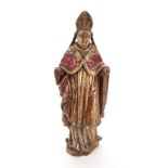 A carved gilded and polychrome decorated figure of a standing Bishop, 17th/18th century, 41cm high.