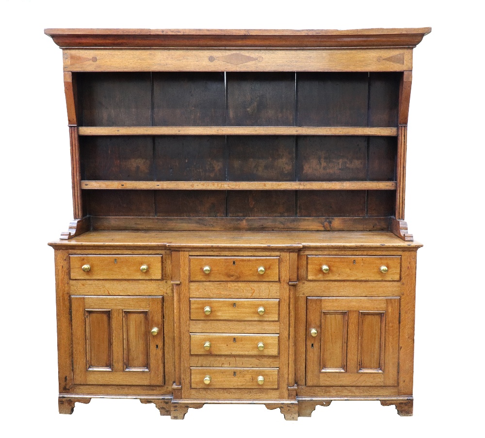 A George III oak and mahogany dresser, the boarded shelved rack with a lozenge,