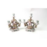 A pair of Sitzendorf porcelain three light candelabrum, encrusted with flowers,