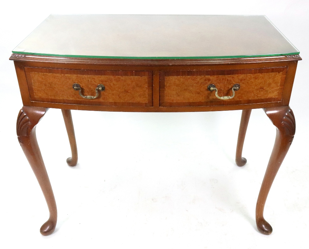 A reproduction George II style burr walnut and crossbanded bow fronted side table, with two drawers,