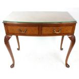 A reproduction George II style burr walnut and crossbanded bow fronted side table, with two drawers,