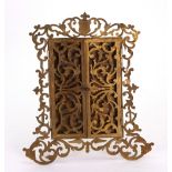 A French gilt metal easel photograph frame, circa 1870, leafy scroll pierced and engraved,
