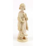 A Japanese ivory okimono of a bijin, Meiji period, the young woman carved standing with a rake,
