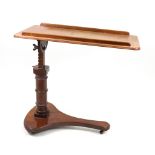 A Victorian mahogany bed table, circa 1870, the moulded rectangular adjustable top,