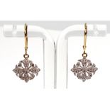 A pair of diamond set pendant earrings in a stylised geometric floral design,