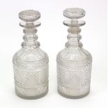 A pair of Regency diamond split and facet cut glass decanters,