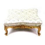 A large reproduction Louis XV style carved giltwood frame square stool, with concave sides,