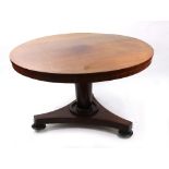 An early Victorian mahogany dining table, the circular tilt top on a cylindrical tapering pillar,