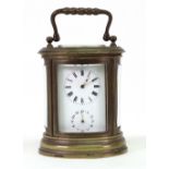 A French miniature oval brass cased carriage clock with alarm, Stamped 'A.