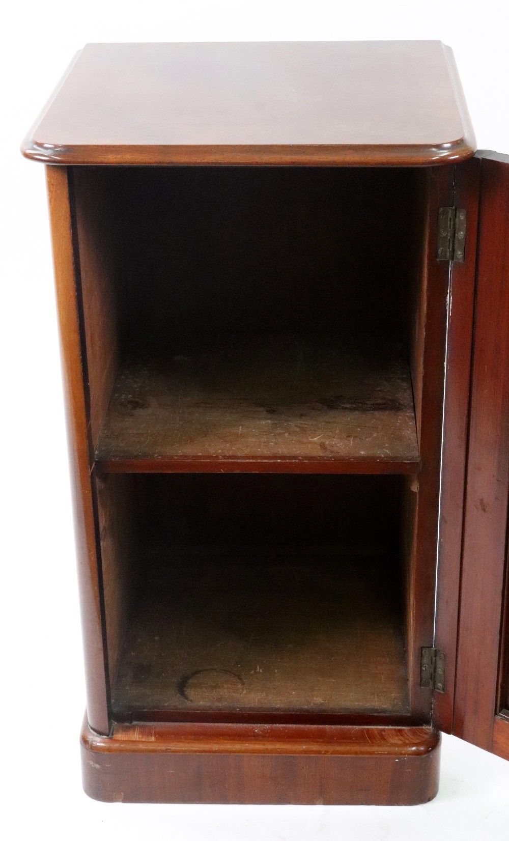 A Victorian mahogany pot cupboard, circa 1860, enclosed by a panelled door, on a plinth base, - Image 2 of 2