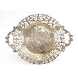 An ornate Dutch silver shaped circular two-handled dish, English import marks for 1891,