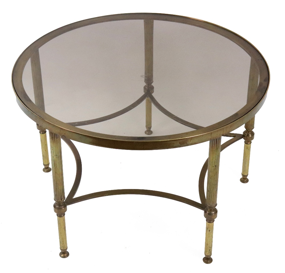 A modern brass frame circular glass top coffee table, on reeded legs, 61.