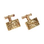 A pair of yellow metal rectangular panel cufflinks, with textured finish and curved profile,