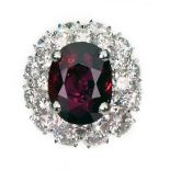 A ruby and diamond oval cluster ring, MOIRA, London 2008, the oval mixed cut ruby weighing 8.
