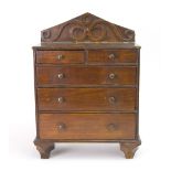 Miniature furniture - a Victorian oak chest, circa 1880, with a scroll carved arched back,