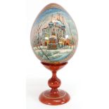 A painted wood Russian egg on stand, 20th century,