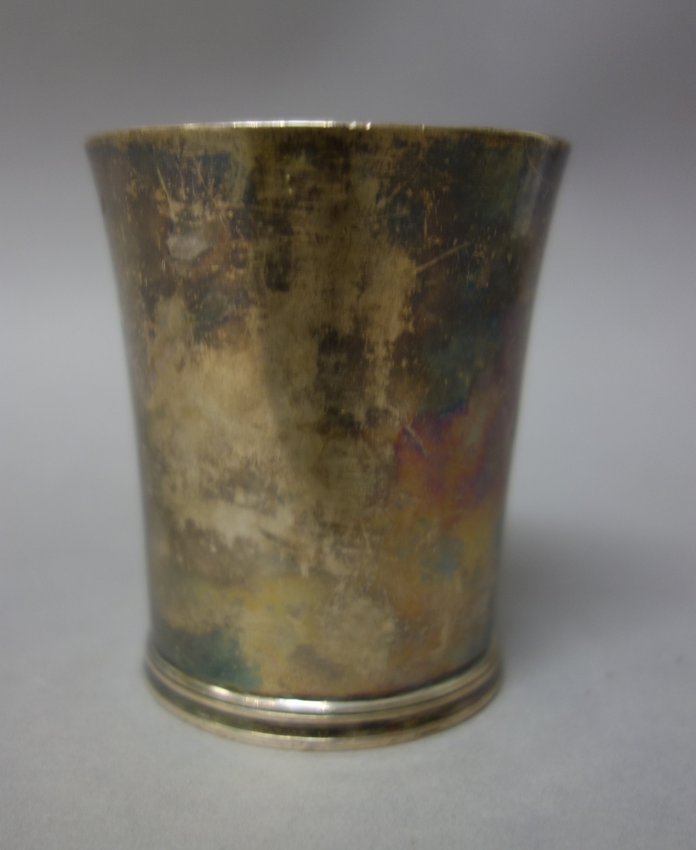 A George III silver beaker, of tapered cylindrical form, height 8.3cm, London 1790, weight 130 gms.