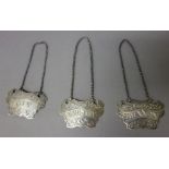 A pair of Victorian silver decanter labels, each of cartouche shaped form, detailed Brandy and Gin,